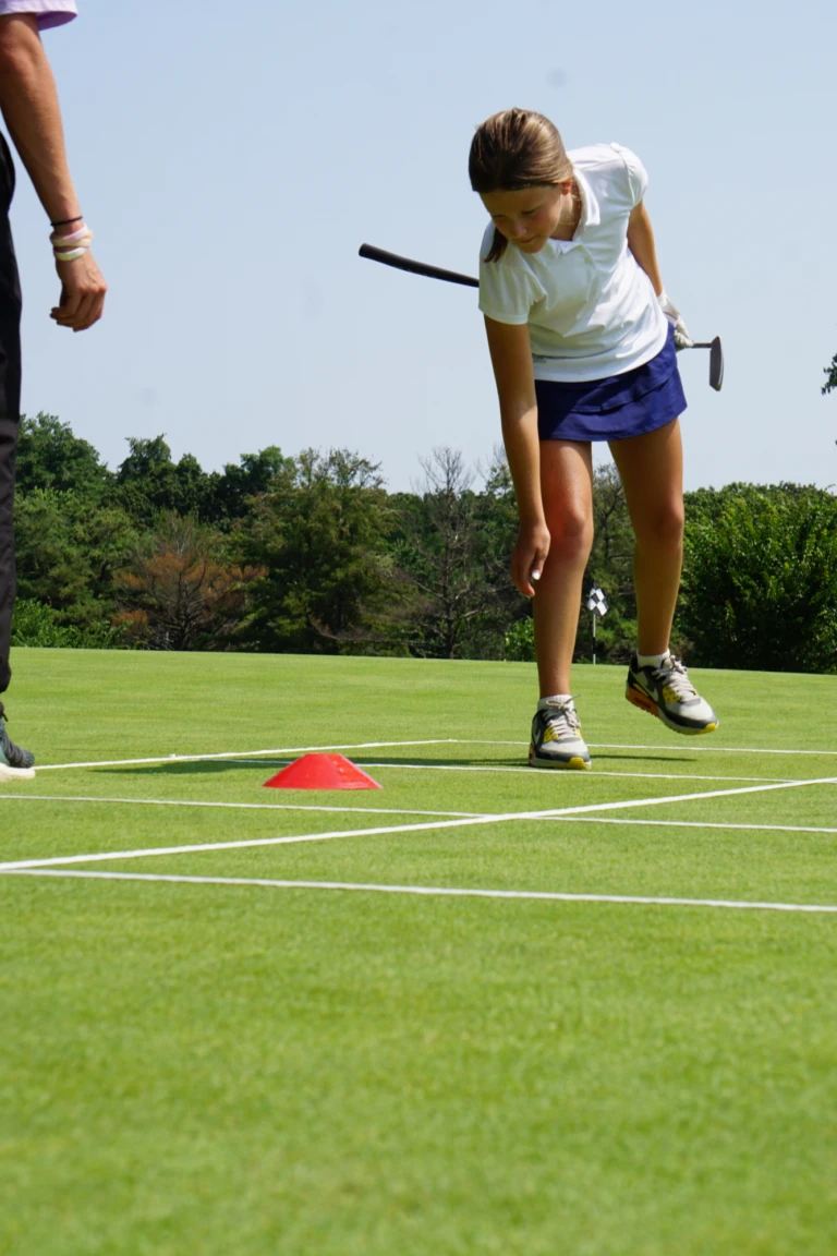 Junior golfer practicing swing at Nike Golf Camp
